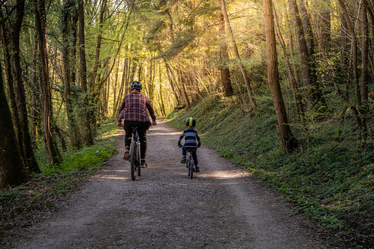 dad and son on bikes through the woods pardoe law